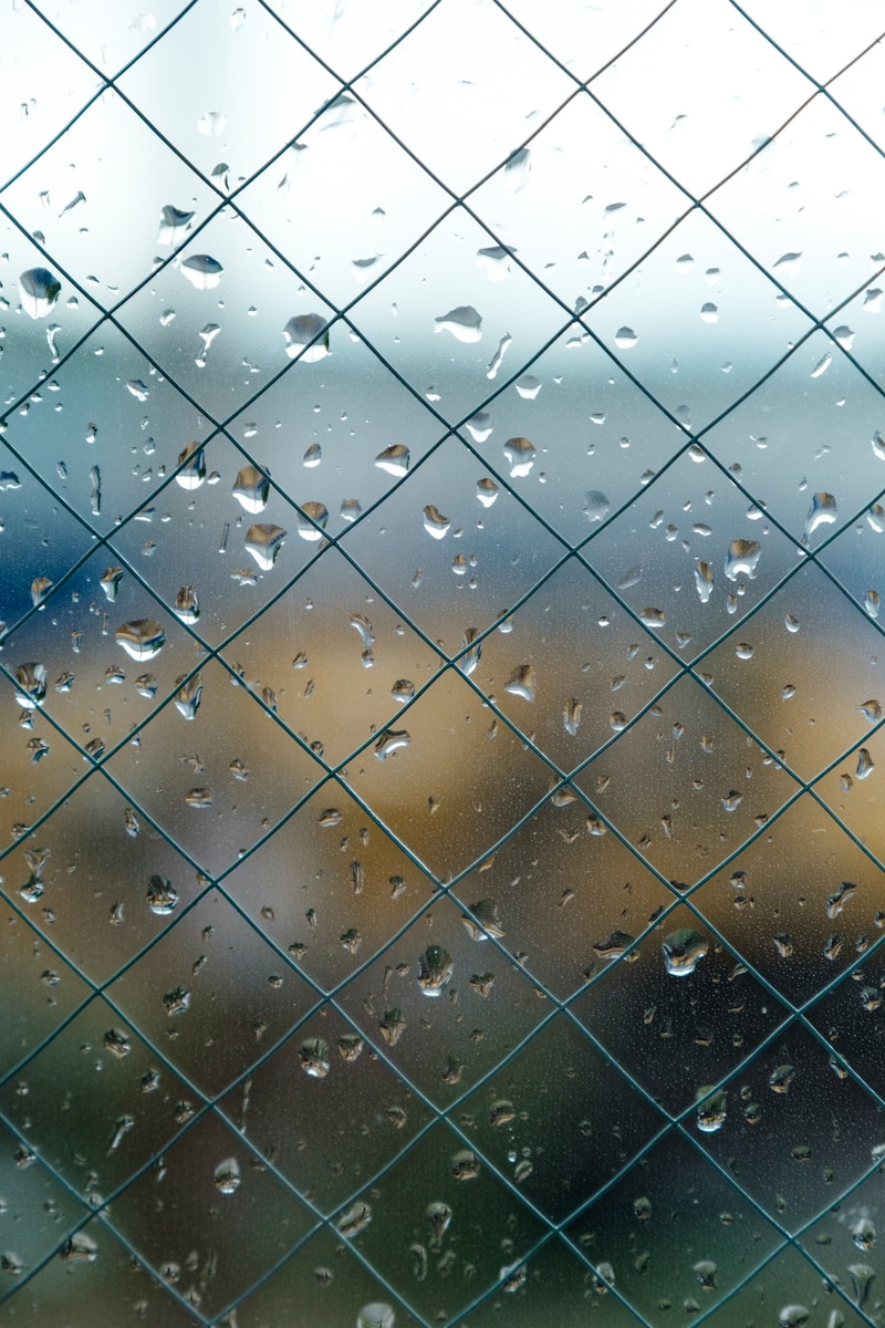 cyclone fence with glass and water moist